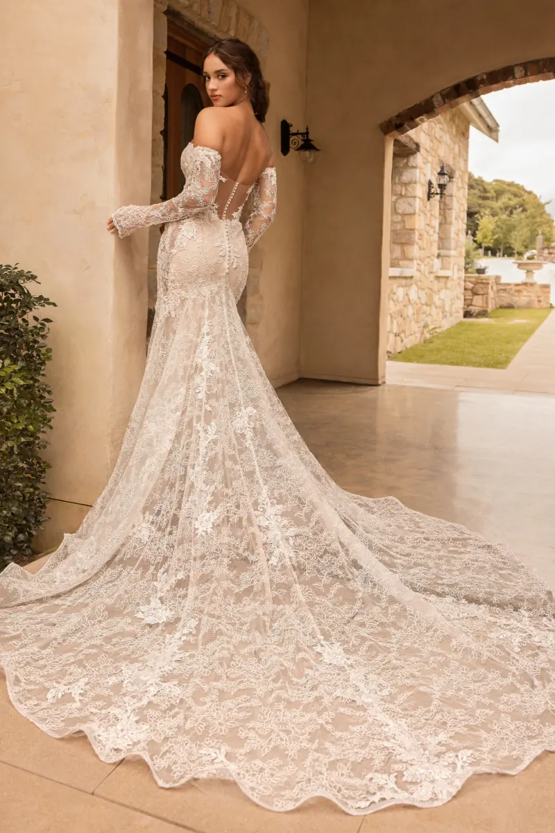 A bride in a lace gown with a long train